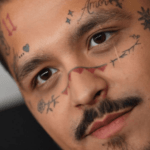 Why did Christian Nodal tattoo his face